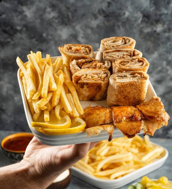 Picture of a plate of chicken shawarma with appetizers